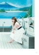 A woman sitting on the edge of a bathtub in a bathroom.